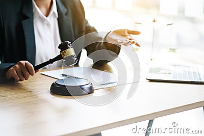 Close up hands of lawyer holds a lawyer`s hammer and explains human rights law Stock Photo