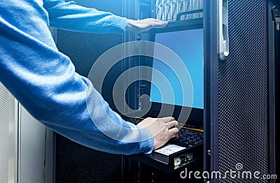 Close up hands of male technician working on laptop and checking problem in server hardware. System administrator in modern data Stock Photo