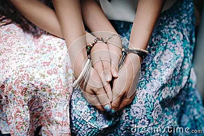 Close up hands of mom and daughter with hippy style accessoriesExpressing love, good trusted family relationship, two generations Stock Photo