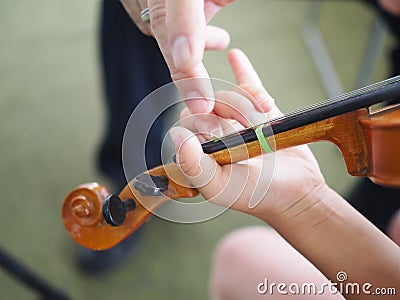 Close up hands of student and teacher on violin lesson Stock Photo