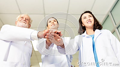 Close up hands team of medical workers holding hands together in hospital. Stock Photo