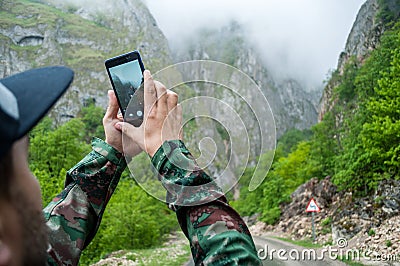 Close-up hands using phone mobile taking photo mountain view on morning Stock Photo