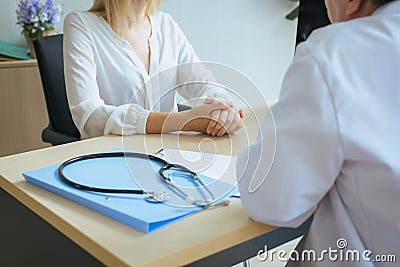 Close up of hand woman talking to doctor psychiatrist in hospital,Discuss issue and find solutions to mental health problems Stock Photo