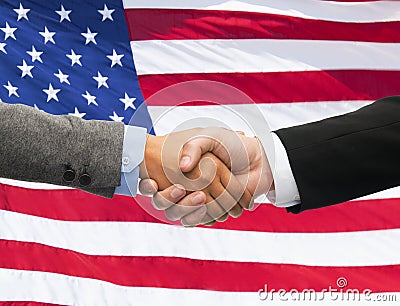 Close up of handshake over american flag Stock Photo