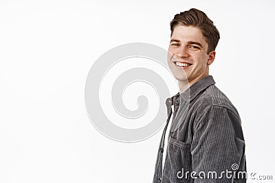 Close up of handsome happy candid boy, young man turn face at camera with white smile, positive cheerful face, looking Stock Photo