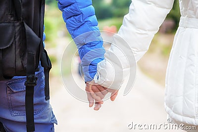 Close-up of a happy couple in love holding hands and walking tog Stock Photo