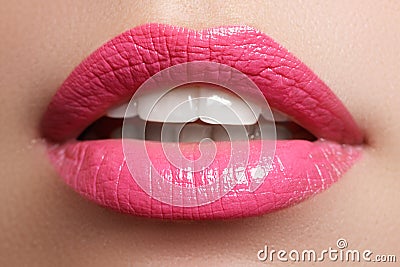 Close-up happy female smile with healthy white teeth, bright red lips make-up. Cosmetology, dentistry and beauty care Stock Photo