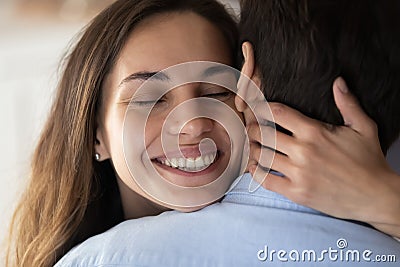 Happy young woman hug beloved husband showing love Stock Photo