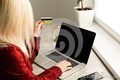 happy woman hand buying online with a laptop and paying with a credit card Editorial Stock Photo