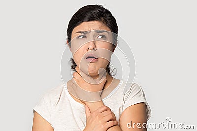 Unhealthy indian young girl holding hand on throat. Stock Photo