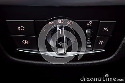 close-up of Headlights control unit with buttons for controlling headlights, fog lamps, parking lights and dimming the dashboard Stock Photo