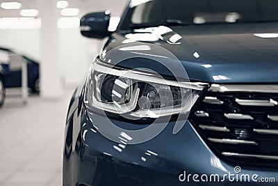 Close-up headlights of a modern blue color car. Detail on the front light of a car. Modern and expensive car concept Stock Photo