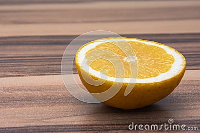 Close up of healthy half of yellow lemon on a wooden table Stock Photo