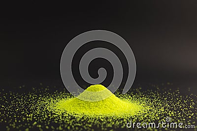 Close up of heap of green sand and copy space on black background Stock Photo