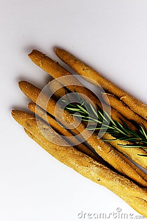 Heap of Italian grissini with rosemary on a white background Stock Photo