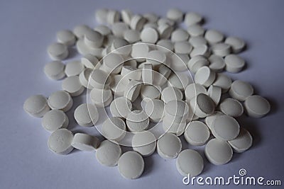 Closeup of heap of white tablets of vitamin K2 Stock Photo