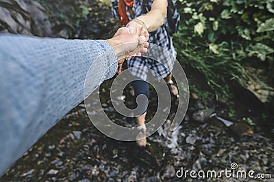 Close-up Of Helping Hand, Hiking Help Each Other. Focus On Hands. People Teamwork Hiking With Motivation And Inspiration. Wide ang Stock Photo