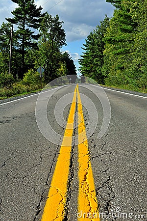 Close up of highway with diminishing yellow lines Stock Photo