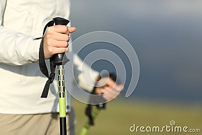 Close up of a hiker hands walking with poles Stock Photo