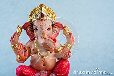 Hindu God Ganesha. Ganesha Idol on blue background Stock Photo