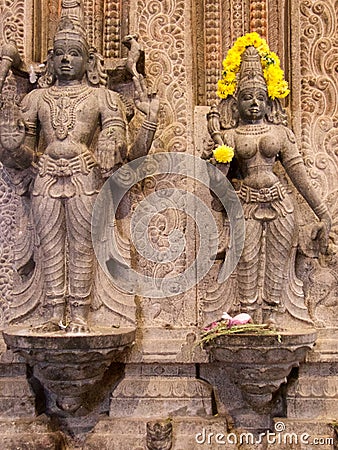 Close up of Hindu goddess with yellow flowers, Trichy, southern India Stock Photo