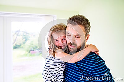 Close up of hipster father holding his crying daughter Stock Photo