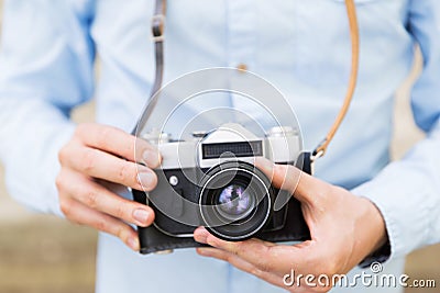 Close up of hipster man with film camera in city Stock Photo