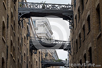 Close up of historic, renovated Butler`s Wharf warehouse building and iron bridges at Shad Thames, London. Editorial Stock Photo