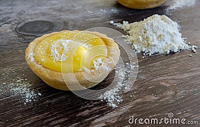 , home-baked Lemon target seen on a table with icing sugar and flour. Stock Photo