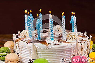 Close up of homemade birthday cake with lots of burning candles Stock Photo