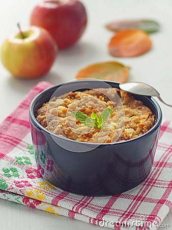 Close up of homemade cake portion served in a mug. Fresh crumble cake with apples. Vertical. Stock Photo