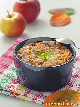 Close up of homemade crumble coffee cake. Portion of apple pie decorated with autumn leaves and fresh mint. Vertical. Stock Photo