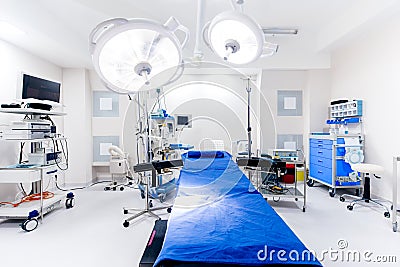 Close up hospital interior. Operating room with surgery lamps and medical equipment Stock Photo