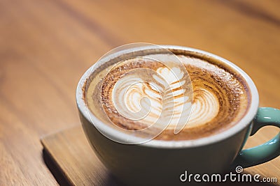 Close up hot cappuccino coffee cup with heart shape latte art on Stock Photo