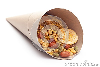 Close-Up of Hot spicy Nav Ratan snacks In handmade handcraft brown paper cone bag, made with red chili, peanuts. Indian spicy Stock Photo
