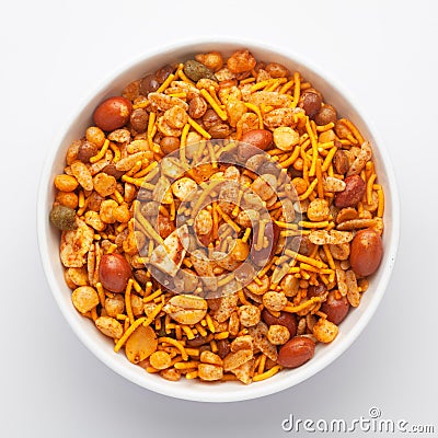 Close-Up of Hot spicy Nav Ratan snacks in a white Ceramic bowl, made with red chili, peanuts. Indian spicy snacks Namkeen, Stock Photo