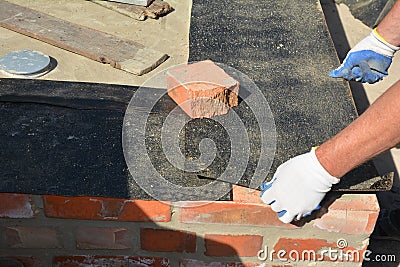 Close up on house foundation wall construction with builder contactor laying waterproofing membrane. House foundation waterprofing Stock Photo