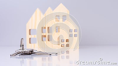 close-up house keys against the background of wooden house models. selective focus. investment, mortgage, real estate Stock Photo