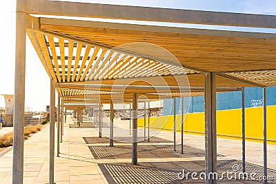Close-up of huts with wooden roofs to provide shade in front of the port of the Forum in barcelona Editorial Stock Photo