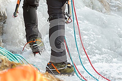 Close up of Ice climbing mountaineer legs with professional sport boots and equipment Stock Photo