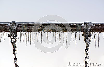 Close Up of Ice Covered Swing Bar and Chains Stock Photo