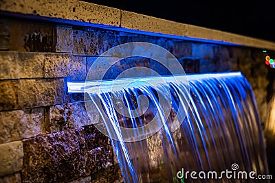 A close-up of an illuminated home waterfall at night Stock Photo