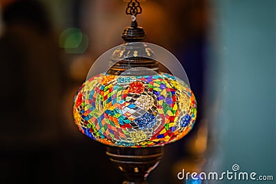 Close up of illuminated multi coloured mosaic patterned glass lamp shade Stock Photo