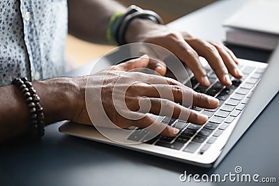 Closeup image african male hands typing on laptop keyboard Stock Photo