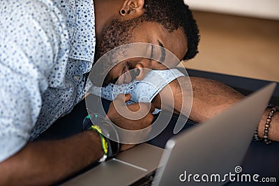 Closeup image African male worker falls asleep at workplace desk Stock Photo