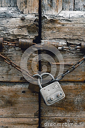 Close-up image of ancient closed doors. Old Italy. Background. Lock and chain. vintage, retro. vertical photo Stock Photo