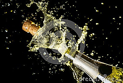 Close up image of champagne cork flying out of champagne bottle. Celebration theme with explosion of splashing champagne sparkling Stock Photo