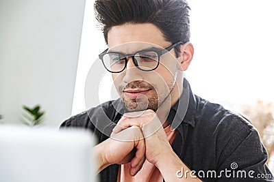 Close up image of concentrated serious handsome man in eyeglasses Stock Photo