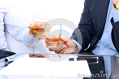 Close-up image of a contract . two colleagues celebrate signing a contract with Whisky Stock Photo