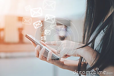 Close-up image of female hands using smartphone with icon envelope email Stock Photo